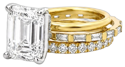 Emerald-cut diamond ring stacked with diamond bands in yellow gold